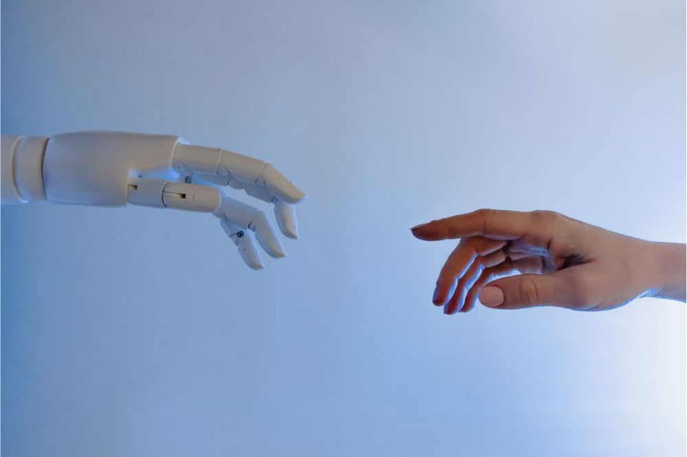 Ai and human hand reaching out to one another